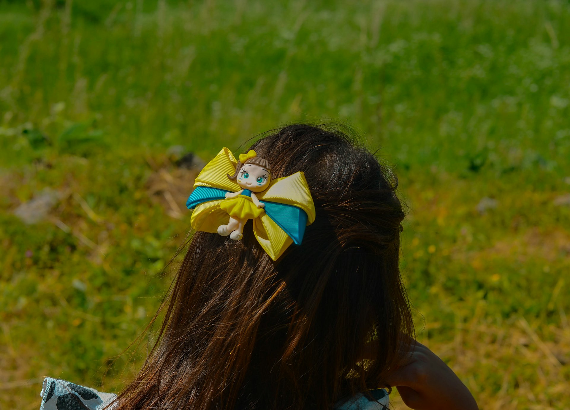 Girl's hair features a decorative bow.